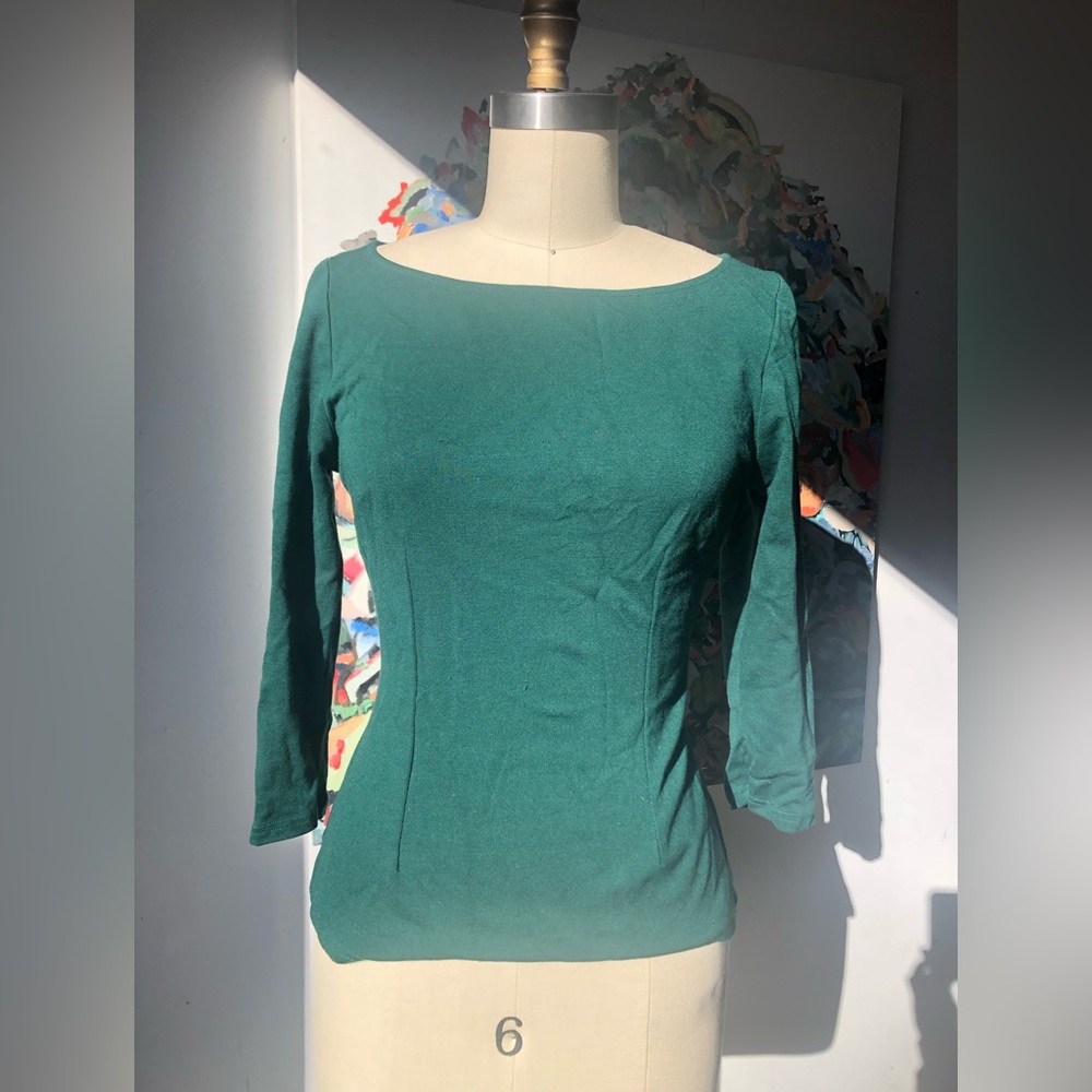 Laura Byrnes of Pinup girl clothing vintage inspired green top